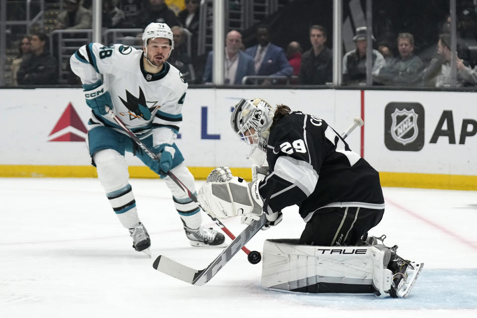 Los Angeles Kings goaltender Pheonix Copley, right, stops a shot by San Jose Sharks center Tomas Hertl, left, during the first period of an NHL hockey game Wednesday, Jan. 11, 2023, in Los Angeles. (AP Photo/Mark J. Terrill)
