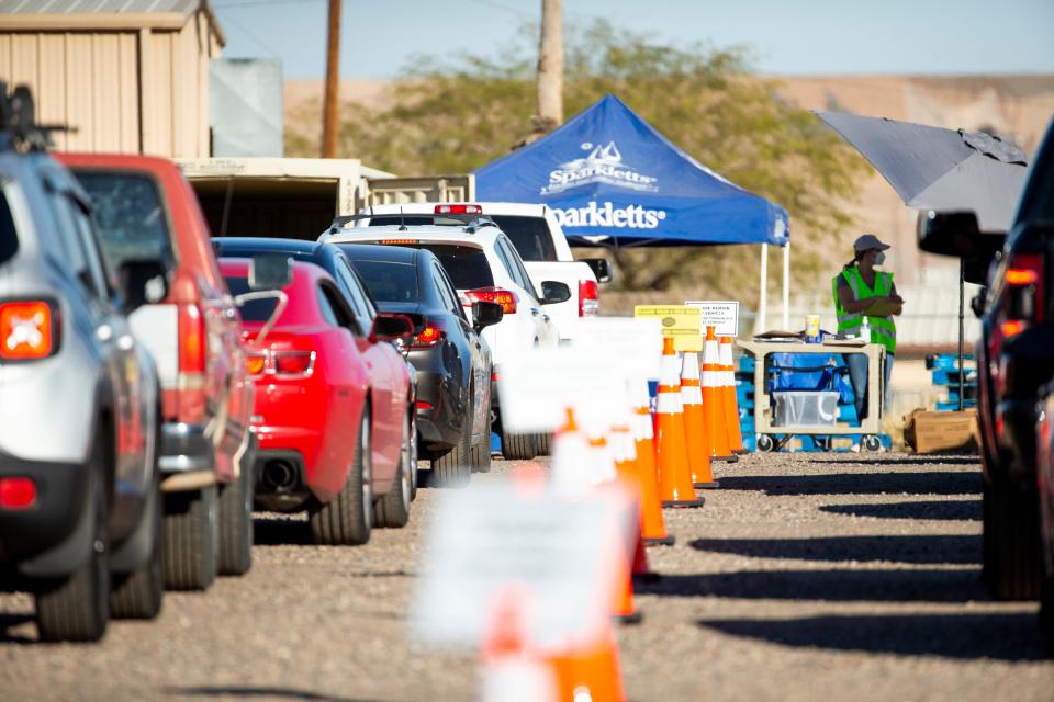 Contractors working with the United States Air Force distribute bottled water at a site near Luke Air Force Base in Glendale on Feb. 23, 2021. The water was being distributed to residents after high levels of contaminants known as "forever chemicals" coming from the Air Force base were found in the community’s drinking water.