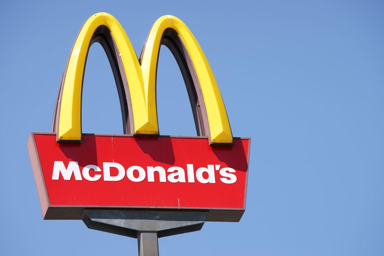 Ljubljana, Slovenia - September 3, 2011: Close-up of McDonalds outdoor sign with  typical rounded yellow M letter against cloudless blue sky. Sign is positioned on the left side of image.