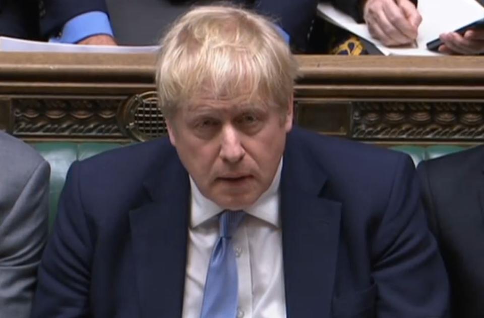 Prime Minister Boris Johnson listens as Labour leader Sir Keir Starmer responds to his statement to MPs in the House of Commons on the Sue Gray report. Picture date: Monday January 31, 2022.