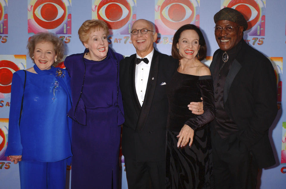 FILE - In this Nov. 2, 2003 file photo, actors Betty White, left, Georgia Engel, second left, Gavin MacLeod, center, Valerie Harper, second right, and John Amos pose for photographers during arrivals at CBS's 75th anniversary celebration in New York. Gavin MacLeod has died. His nephew told the trade paper Variety that MacLeod died early Saturday, May 29, 2021. (AP Photo/Louis Lanzano, File)