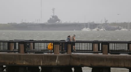 People check out the sights along the waterfront ahead of the arrival of Hurricane Dorian