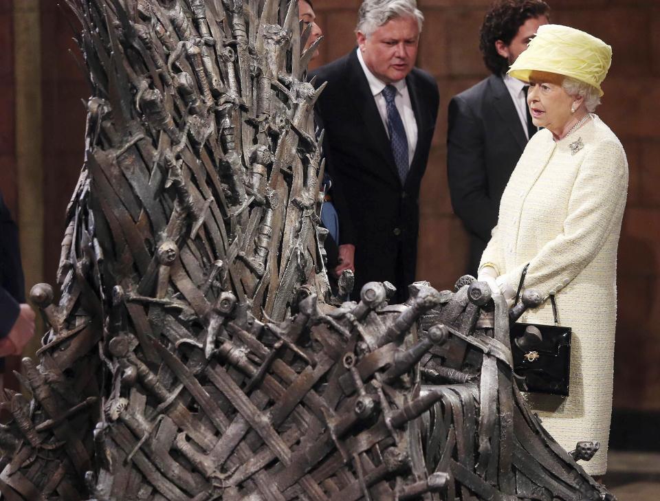 Britain's Queen Elizabeth looks at the Iron Throne as she visits the set of TV series Game of Thrones, in Belfast