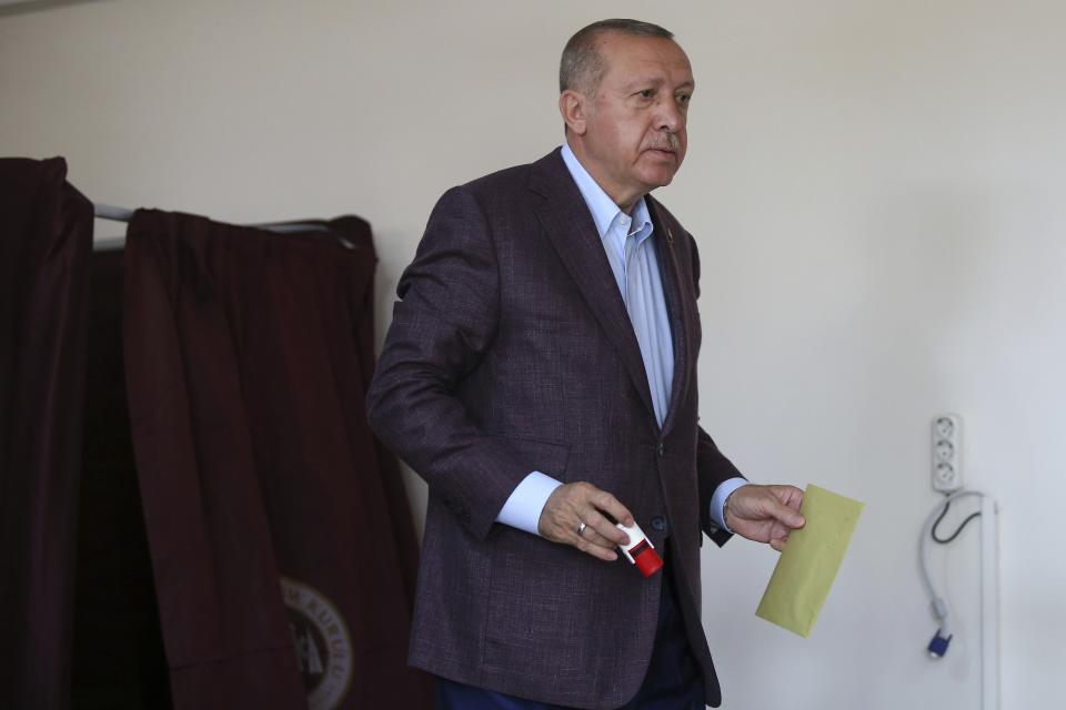 Turkey's President Recep Tayyip Erdogan casts his ballot at a polling station in Istanbul, Sunday, June 23, 2019. Polls have opened in a repeat election in Turkey's largest city where Erdogan and his political allies could lose control of Istanbul's administration for the first time in 25 years. (AP Photo/Emrah Gurel)