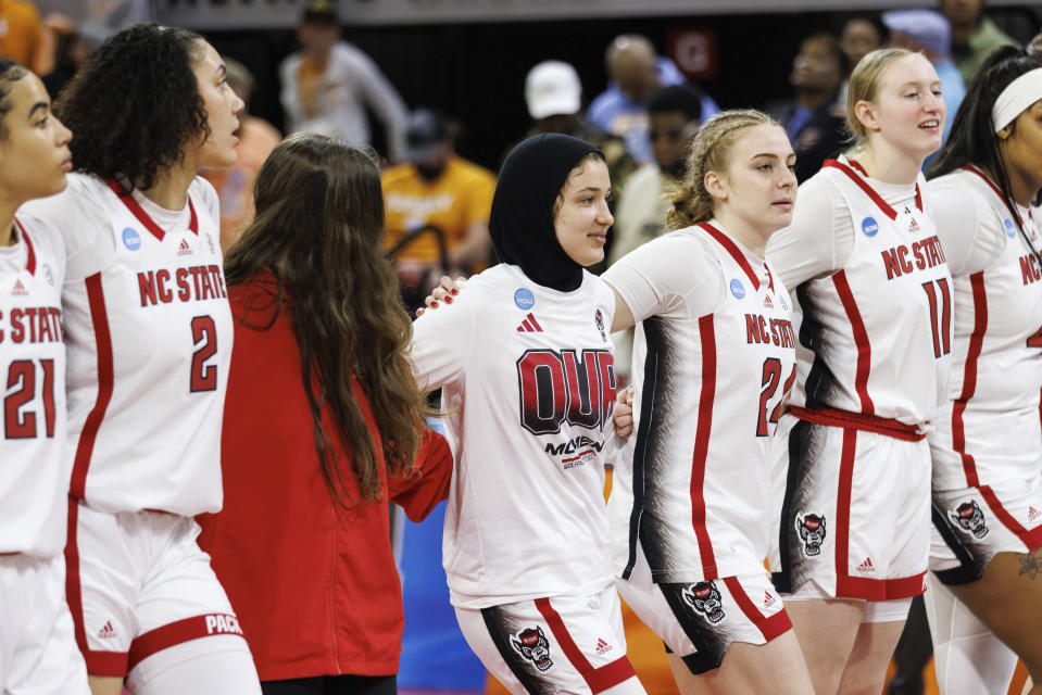 North Carolina State's Jannah Eissa, middle, celebrates with her team after defeating Tennessee in a second-round college basketball game in the NCAA Tournament in Raleigh, N.C., Monday, March 25, 2024. (AP Photo/Ben McKeown)