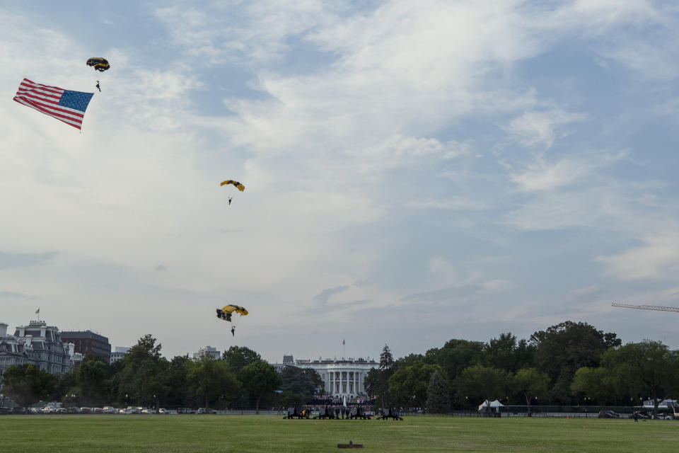 President Donald Trump and first lady Melania Trump watch as the U.S. Army Golden Knights Parachute Team descend during a "Salute to America" event on the South Lawn of the White House, Saturday, July 4, 2020, in Washington. (AP Photo/Alex Brandon)