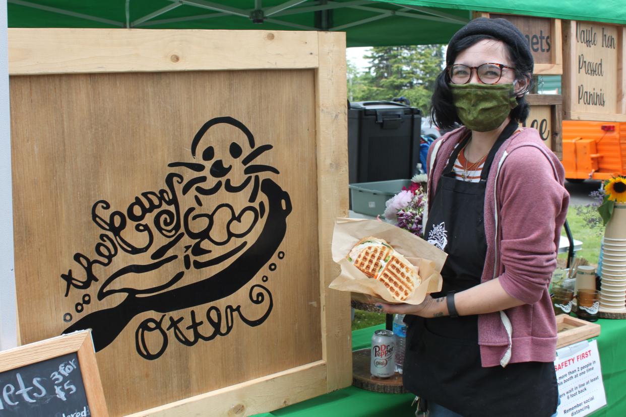 Lindsay Pilapil, owner of The Easy Otter, holds one of her waffle pressed panini at the Thursday Market in West Salem in June 2020.