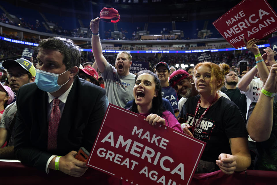 President Donald Trump supporters cheer as they attend a campaign rally at the BOK Center, Saturday, June 20, 2020, in Tulsa, Okla. (AP Photo/Evan Vucci)