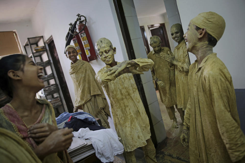 School children dress up as statues depicting Indian freedom leader Mahatma Gandhi's Dandi March, on the eve of Gandhi's 150th birth anniversary in New Delhi, India, Tuesday, Oct. 1, 2019. Dandi March is the name given to the Salt Satyagraha (Salt March) where Gandhi and other freedom fighters marched 241 miles to the sea to make their own salt on April 6, 1930 as an act of civil disobedience against the British colonial rule. (AP Photo/Altaf Qadri)