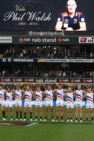 Crows players hold a moment's silence.