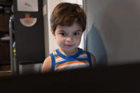 Logan Strauss, 5, participates in an online class from home, Wednesday, July 28, 2021, in Basking Ridge, N.J. Logan's parents are keeping him out of school until he gets the COVID-19 vaccine. (AP Photo/Mark Lennihan)