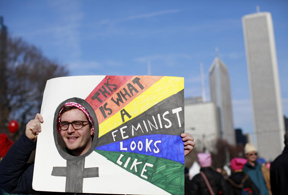 <p>A man holds up a sign as he takes part in the Second Annual Womens March Chicago on Jan. 20, 2018 in Chicago, Ill. ((Photo: Jim Young/AFP/Getty Images) </p>