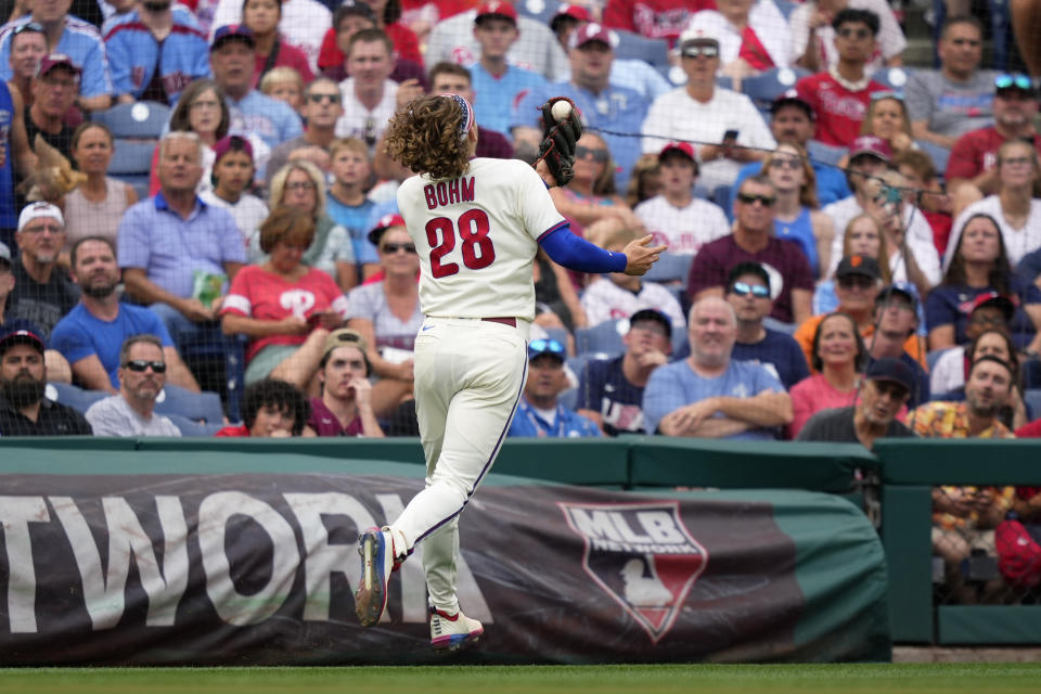 Philadelphia Phillies third baseman Alec Bohm catches a pop foul out by San Francisco Giants' LaMonte Wade Jr. during the fourth inning of a baseball game, Wednesday, Aug. 23, 2023, in Philadelphia. (AP Photo/Matt Slocum)