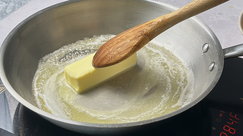 stirring butter in skillet