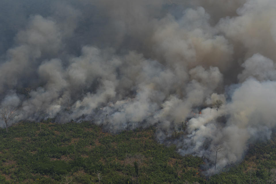 Wildfires consume an area near Porto Velho, Brazil, Friday, Aug. 23, 2019. Brazilian state experts have reported a record of nearly 77,000 wildfires across the country so far this year, up 85% over the same period in 2018. Brazil contains about 60% of the Amazon rainforest, whose degradation could have severe consequences for global climate and rainfall. (AP Photo/Victor R. Caivano)