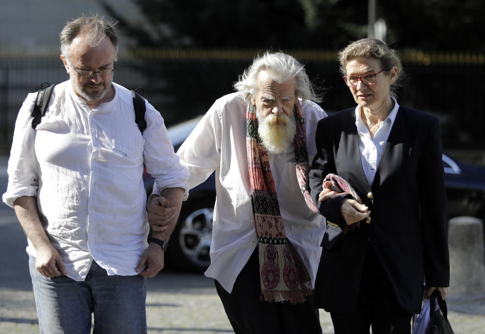 FILE - In this Aug.12, 2019 file photo, French/British actor Michael Lonsdale, center, arrives for the funeral of French film director Jean Pierre Mocky at Saint Sulpice church in Paris. Michael Lonsdale, a French-British actor and giant of the silver screen and theatre in France, died on Monday, his agent said. From his role as villain in the 1979 James Bond film "Moonraker" to that of a monk in Algeria in "Of Gods and Men," Lonsdale worked, often in second roles, with top directors from Orson Wells to Spielberg. (AP Photo/Lewis Joly, File)