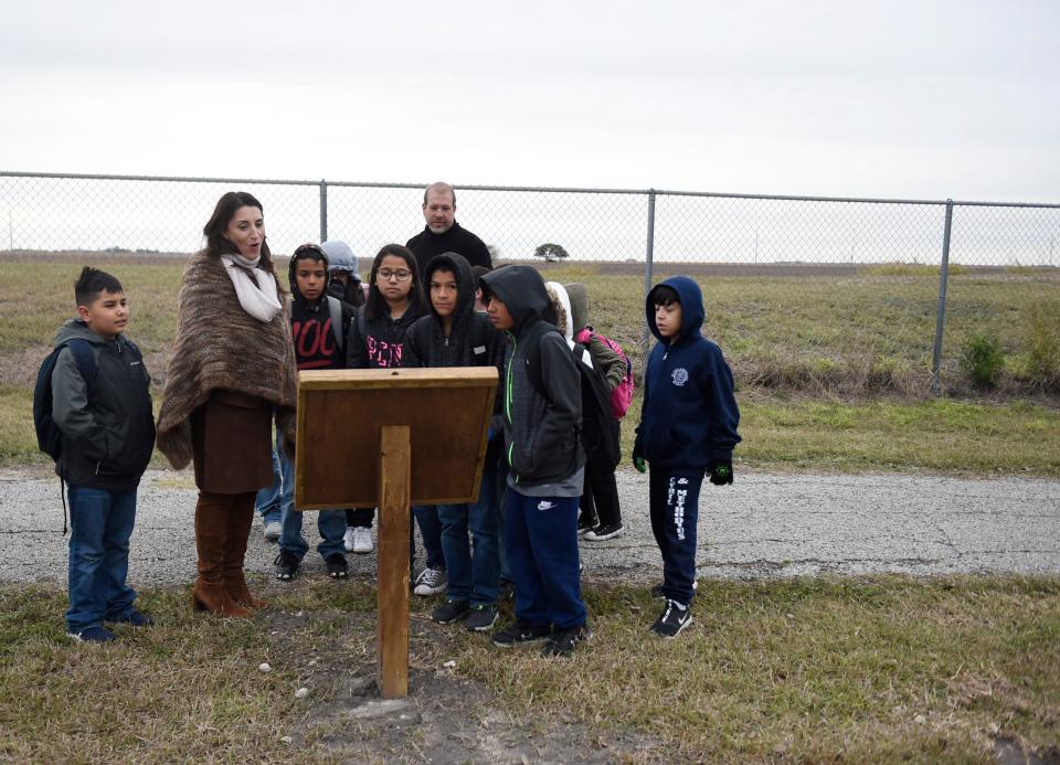 Nueces Judge Barbara Canales walks with children Wednesday through the StoryWalk at Oscar O. Ortiz Park in Robstown, Texas. Canales read the story "We're Going on a Bear Hunt" by Michael Rosen while walking with kids.