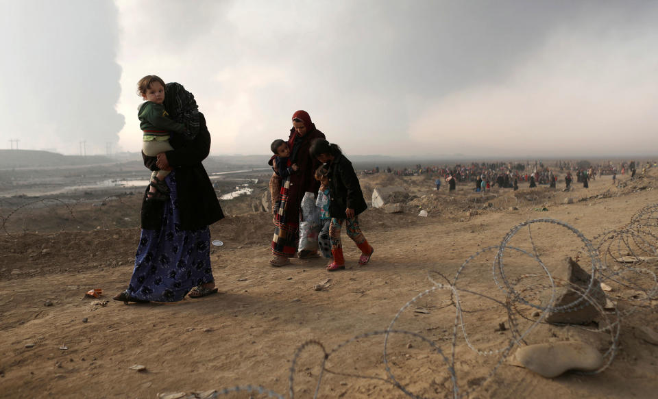 A newly displaced woman carries her child