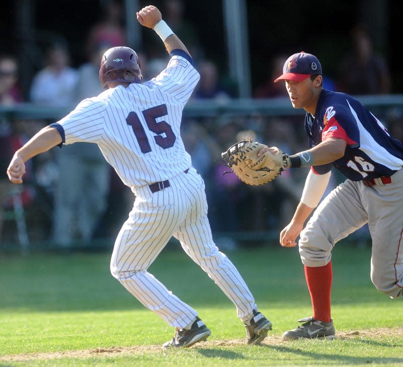 Cotuit 08/09/12  Patrick Biondi of Cotuit is caught in his tracks between home and third by Bourne third baseman Mike Ahmed. Cape League baseball 080812rs07
Cape Cod Times/Ron Schloerb