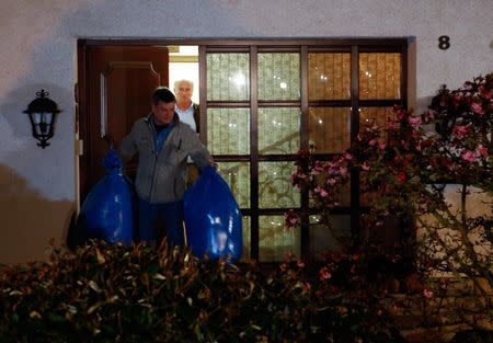 German police officers carry bags out of a house believed to belong to the parents of crashed Germanwings flight 4U 9524 co-pilot Andreas Lubitz in Montabaur, March 26, 2015. REUTERS/Kai Pfaffenbach