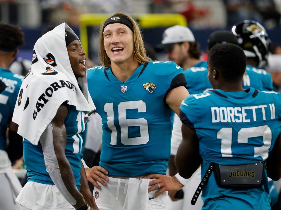 Trevor Lawrence speaks with his teammates during a preseason game.