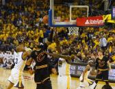 Jun 4, 2017; Oakland, CA, USA; Cleveland Cavaliers guard Kyrie Irving (2) shoots between Golden State Warriors forward David West (3)and forward Draymond Green (23) during the first half in game two of the 2017 NBA Finals at Oracle Arena. Mandatory Credit: Kyle Terada-USA TODAY Sports