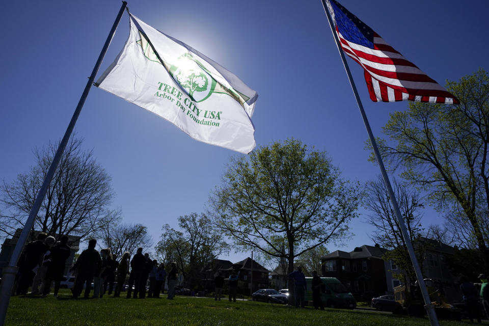 A Tree City USA flag flies in a park during a tree planting ceremony with school children, Friday, April 30, 2021, in Cedar Rapids, Iowa. A rare storm called a derecho plowed through the city of 130,000 last August with 140 mph winds and left behind a jumble of branches, downed powerlines and twisted signs. Now, city officials, businesses and nonprofit groups have teamed up with ambitious plans to somehow transform what is now a city of stumps back into the tree-covered Midwestern oasis along the Cedar River. (AP Photo/Charlie Neibergall)