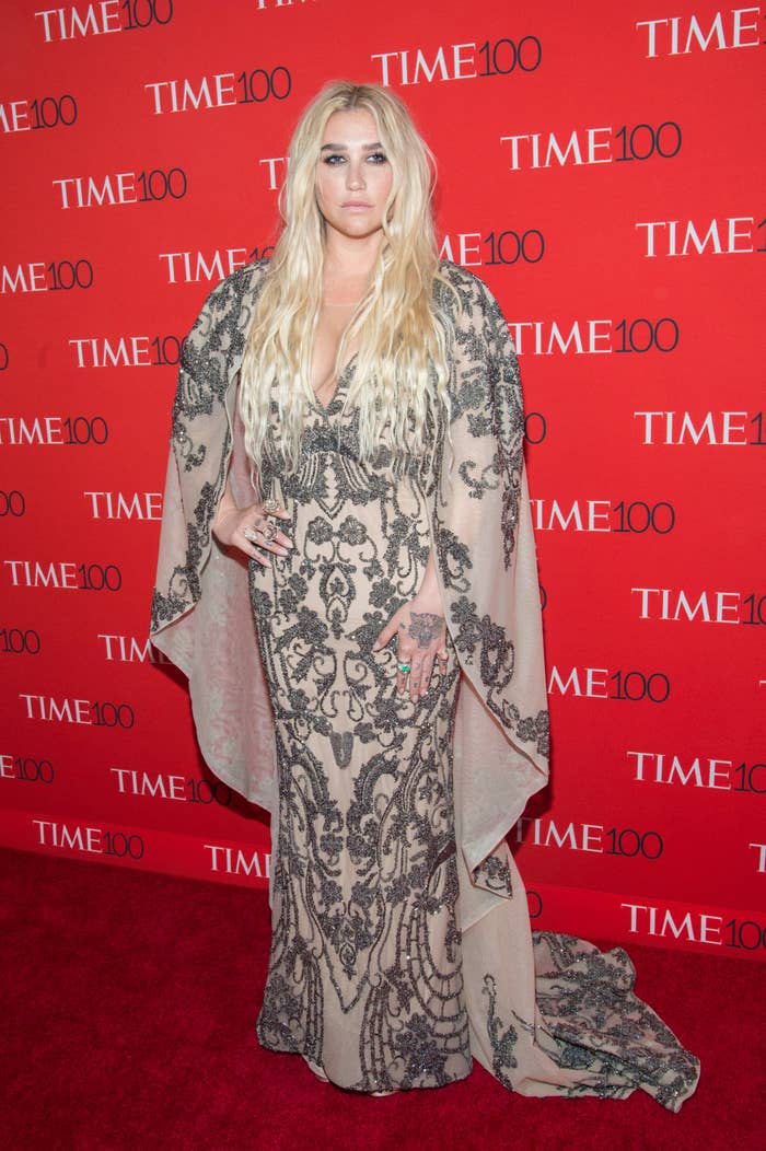 Kesha poses for photographers on the TIME 100 red carpet