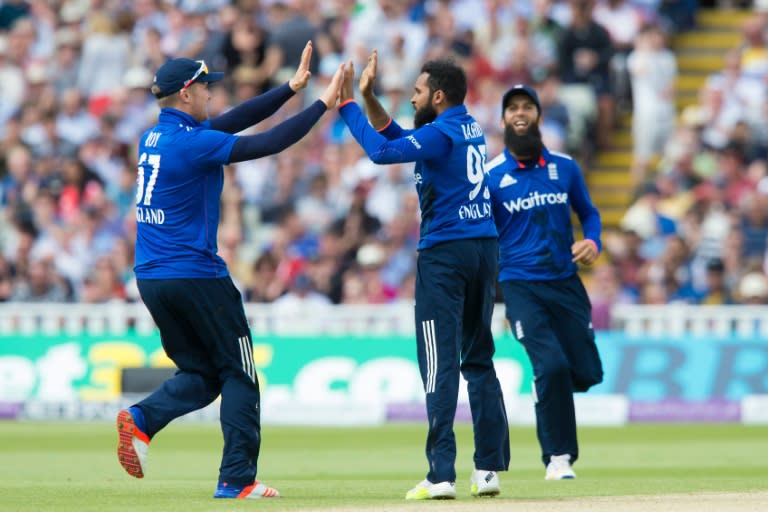 England's Adil Rashid (C) celebrates with teammates after taking the wicket of Sri Lanka's Angelo Mathews during play in the second one day international at Edgbaston, on June 24, 2016