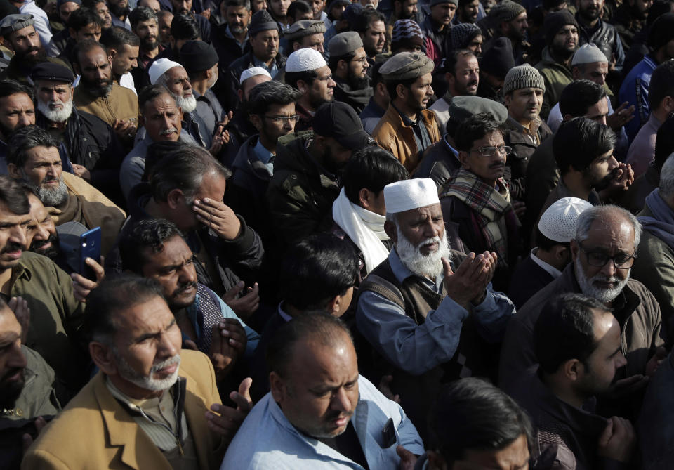 People attend the funeral ceremony for six victims from one family that were killed after being stuck in their vehicles overnight during a heavy snowstorm as temperatures plummeted, in the area of the Murree Hills resort, in Rawalpindi, adjacent to Pakistan's capital of Islamabad, Sunday, Jan. 9, 2022. Officials said at least 22 people, including 10 children, died in the popular mountain resort town. (AP Photo/Rahmat Gul)