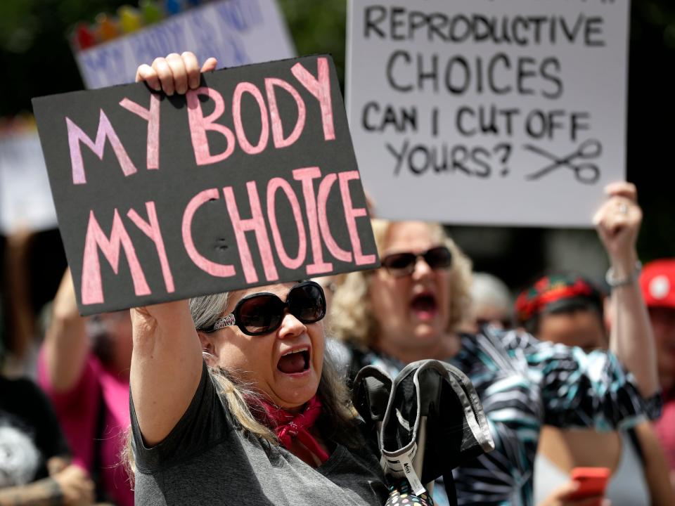 Protesters hold signs at an abortion rally at the Texas State Capitol in 2019.