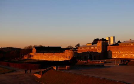 A group of visitors walks outside the former concentration camp in Mauthausen, Austria, November 29, 2016. REUTERS/Leonhard Foeger/Files