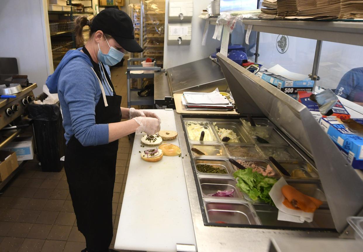 Tiffany Kowalski makes a sandwich at the Monkey Junction Beach Bagels location in Wilmington, N.C., Tuesday, January 11, 2022. Like many businesses in the area they have had trouble with staffing.