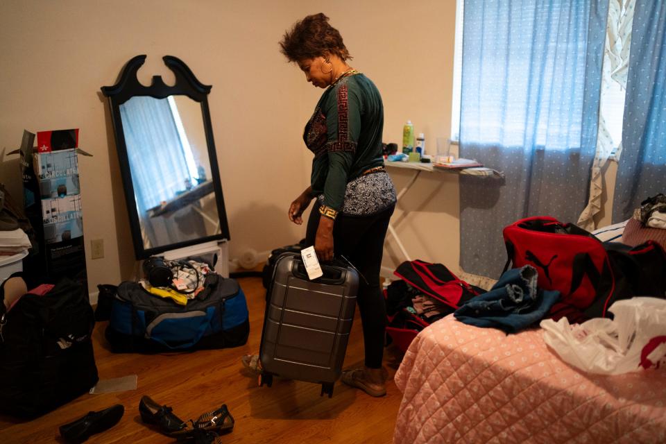 Elissa Nelson, a Haitian immigrant, packs her bags Tuesday in preparation to move from her Colonial Village apartment. Management at the East Side complex has given all of its residents until Dec. 31 to find new housing.