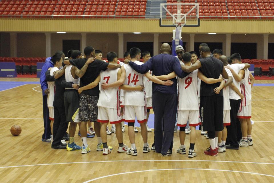 Dennis Rodman huddles with North Korean basketball players and fellow former NBA stars at a practice session in Pyongyang, North Korea on Tuesday, Jan. 7, 2014. Rodman came to the North Korean capital with a squad of U.S. basketball stars for an exhibition game on Jan. 8, the birthday of North Korean leader Kim Jong Un. (AP Photo/Kim Kwang Hyon)