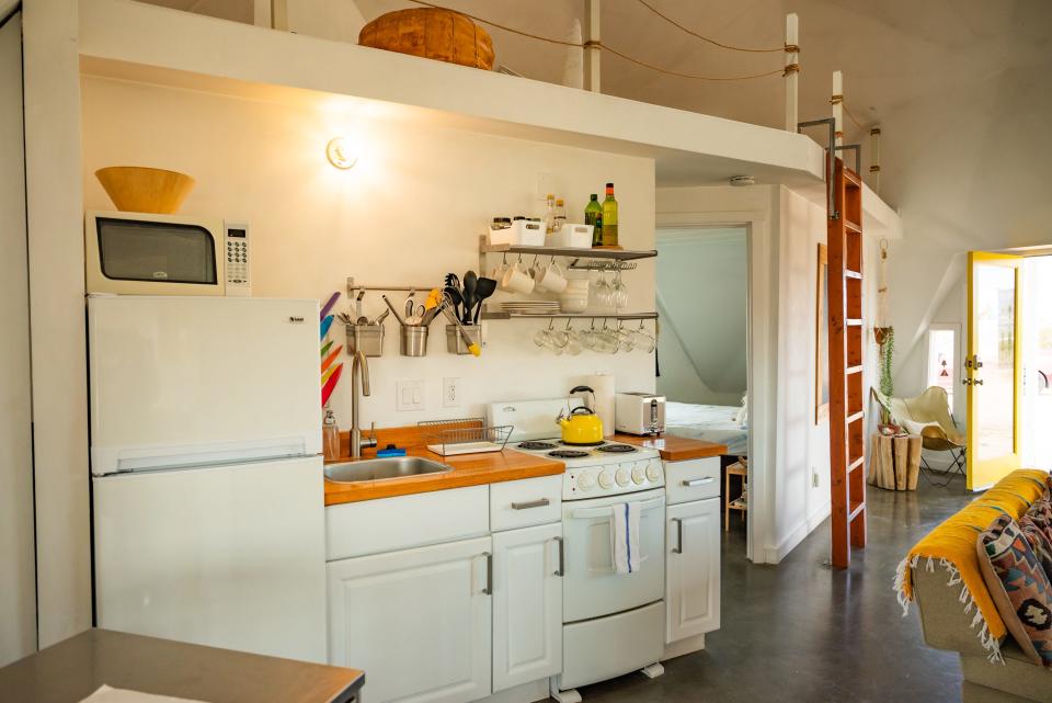 Small white kitchen area in Joshua tree dome