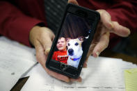 Jackson County Municipal Court Judge Mark T. Musick displays an image of Brandon, a young man he helped raise as a son, as he sits at his bench, Wednesday, July 17, 2019, in Jackson, Ohio. Musick presides over the local drug court in an area heavily damaged by the opioid epidemic. The image was sent by Brandon hours before his fatal overdose on opioids and serves as the home screen image on the judge's phone. (AP Photo/John Minchillo)