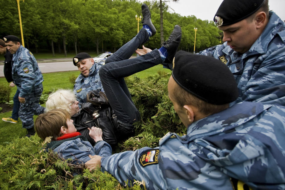 FILE - A Russian Gay Rights protester is taken away by riot police officers in Moscow, Russia, Saturday, May 16, 2009. Russia passed a law in 2013 that bans the depiction of homosexuality to minors, something human rights groups views as a way to demonize LGBT people and discriminate against them. (AP Photo/Roustem Adagamov, File)