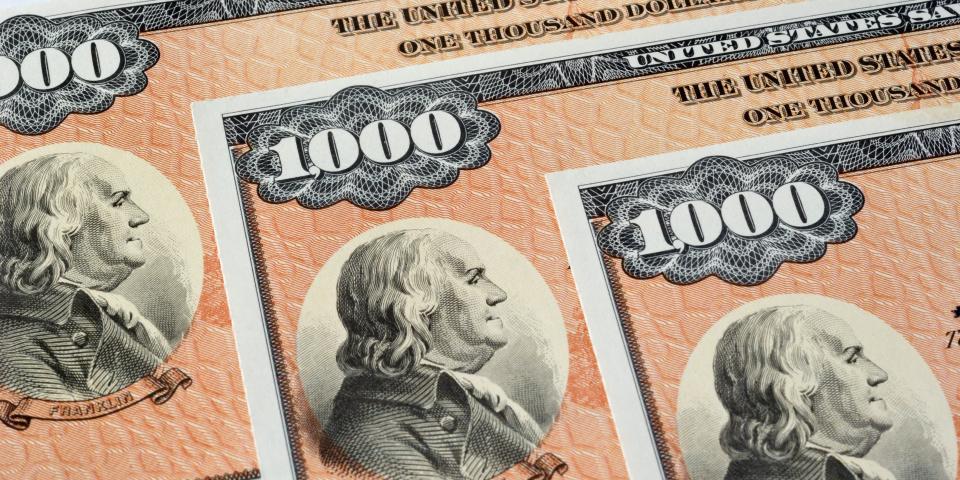 Detail photograph of three $1000 U.S. Savings Bonds.