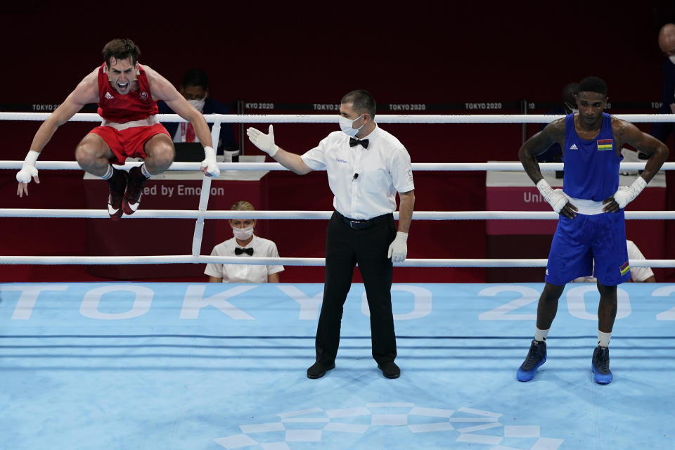 Ireland's Aidan Walsh, left, reacts after defeating Merven Clair, of Mauritius, Aidan Walsh, of Ireland, left, and Merven Clair, of Mauritius, in their welter weight 69kg quarterfinal boxing match at the 2020 Summer Olympics, Friday, July 30, 2021, in Tokyo, Japan. (AP Photo/Frank Franklin II)