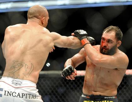 Johny Hendricks (R) considered pulling out of his UFC 171 fight against Robbie Lawler. (AP)