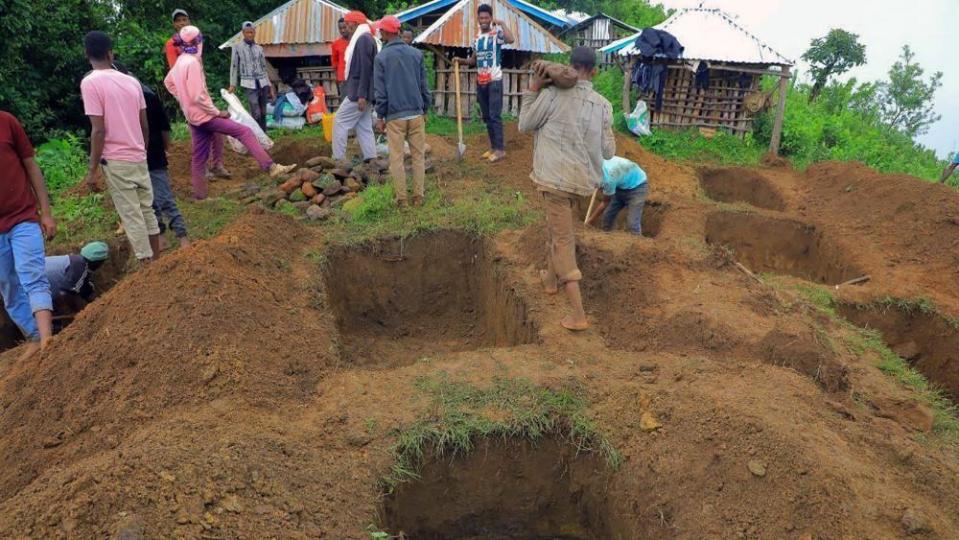 Relatives of victims of a landslide dig graves near the site of the accident in Kencho Sacha Gozdi district, Gofa zone, southern Ethiopia, July 24, 2024