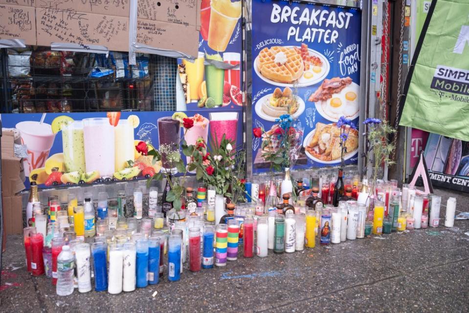 A makeshift memorial for slain bystander Stefon Barnes popped up outside the Bronx bodega where he was killed. LP Media
