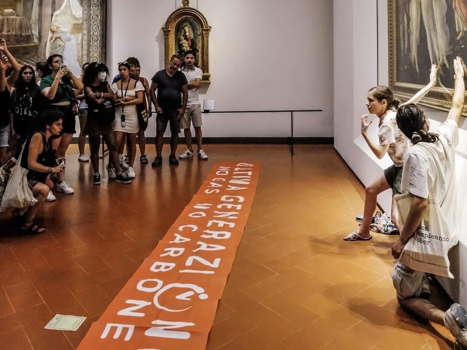 Protesters from the action group Ultima Generazione glue their hands to the glass covering Sandro Botticelli's La Primavera at Uffizi on July 22, 2022 in Florence, Italy.