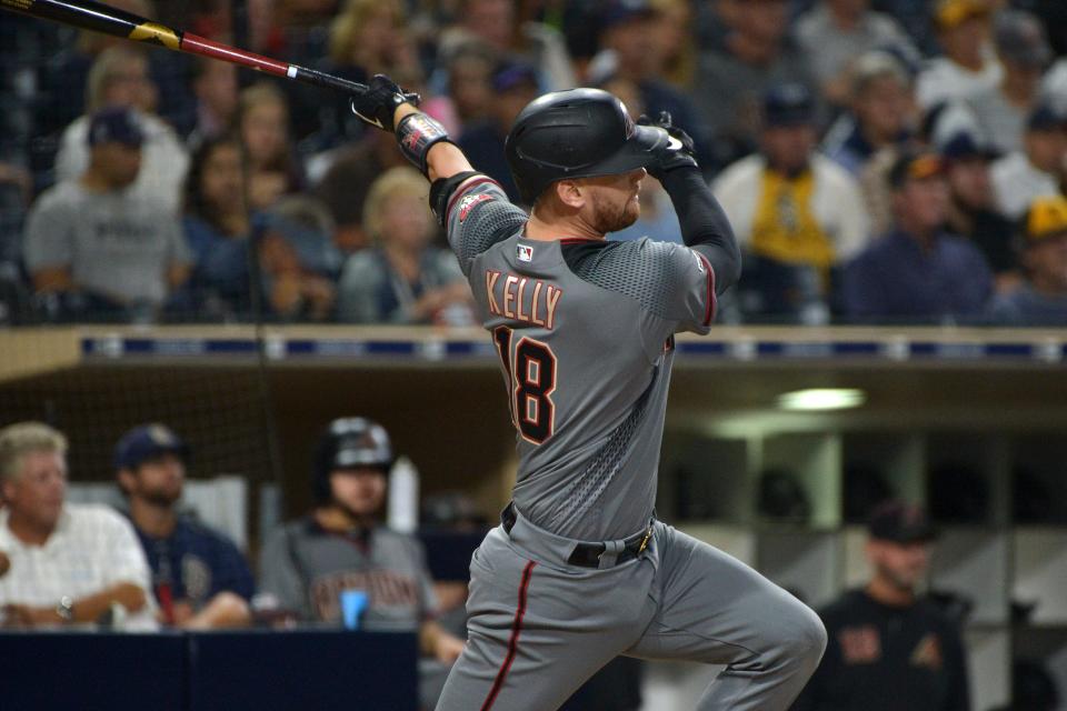 Sep 20, 2019; San Diego, CA, USA; Arizona Diamondbacks catcher Carson Kelly (18) hits a two RBI single in the second inning against the San Diego Padres at Petco Park.