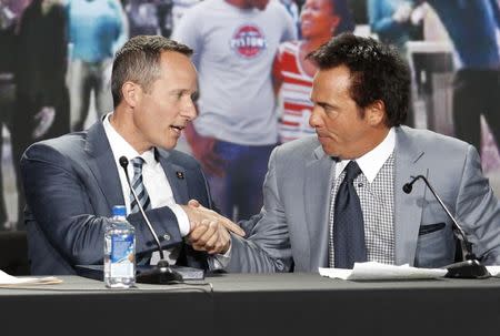 Nov 22, 2016; Detroit, MI, USA; Christopher Ilitch (left) shakes hands with Detroit Pistons owner Tom Gores (right) during a press conference at Cass Tech High School. Mandatory Credit: Raj Mehta-USA TODAY Sports