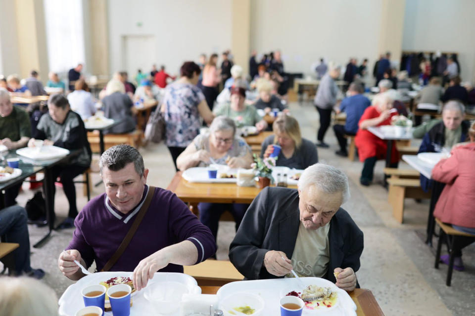 In this photo released by Belgorod regional governor Vyacheslav Gladkov's Telegram channel on Wednesday, March 20, 2024, residents deported from settlements bordering Ukraine have lunch at a temporary accommodation center in Stary Oskol, Belgorod region, Russia. (Belgorod Region Governor Vyacheslav Gladkov Telegram channel via AP)