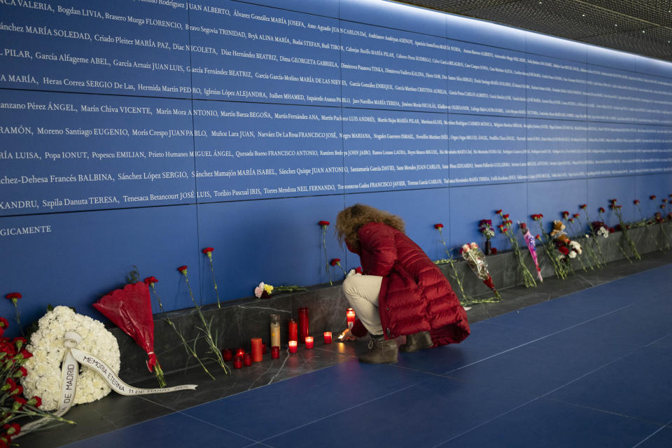 A woman lights a candle at a memorial for the train bombing victims inside Atocha train station in Madrid, Spain on Monday, March 11, 2024. Victims of terror attacks are a symbol of the constant need to guard freedom and the rule of law against threats, Spain’s King Felipe VI said Monday at a ceremony marking the 20th anniversary of Europe’s deadliest terror attack. March 11 was chosen as a day of continent-wide commemoration of terrorism victims after the train bombing in the Spanish capital on March 11, 2004 that killed nearly 200 people. (AP Photo/Bernat Armangue)