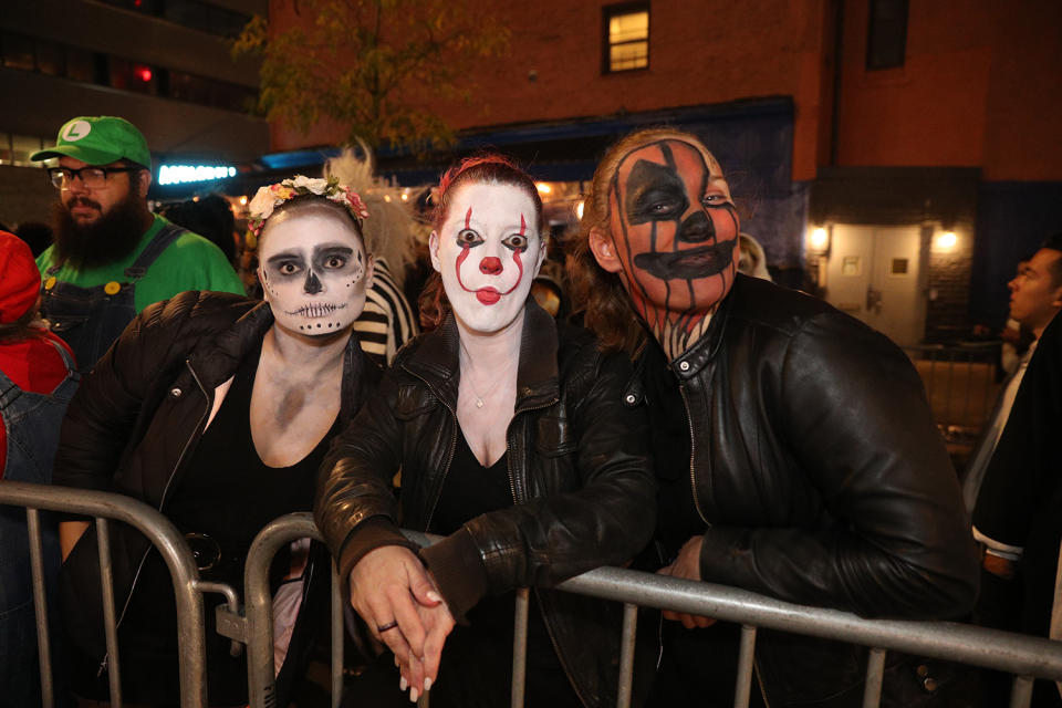 People dressed as goblins and killer clowns wait for the start of the Halloween Parade in New York City. (Photo: Gordon Donovan/Yahoo News)