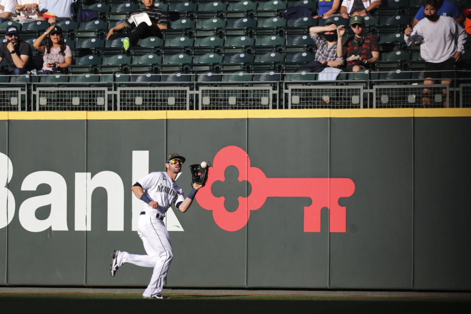 Seattle Mariners right fielder Mitch Haniger makes the catch for the out on Cleveland Indians' Cesar Hernandez during the third inning of a baseball game Saturday, May 15, 2021, in Seattle. (AP Photo/Jason Redmond)